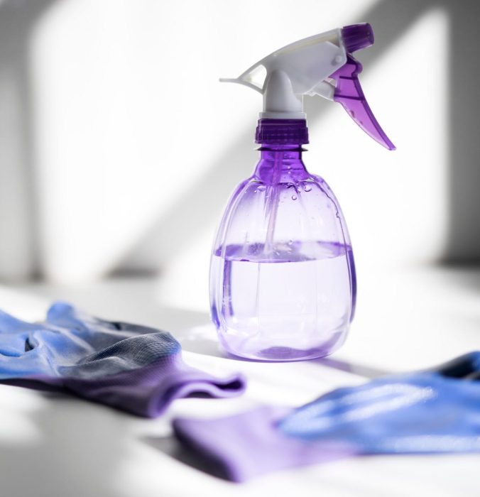 view-of-a-purple-water-cleaning-spray-plastic-bottle-and-bright-purple-cleaning-protection-gloves-on_t20_kodW12